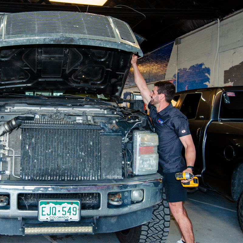 Preparing to repair auto hail damage - removing hood.